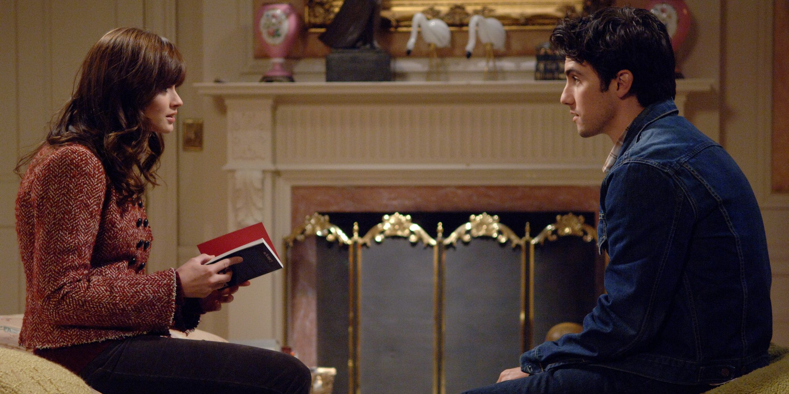Rory and Jess sit in front of a fireplace and talk in Gilmore Girls season 6