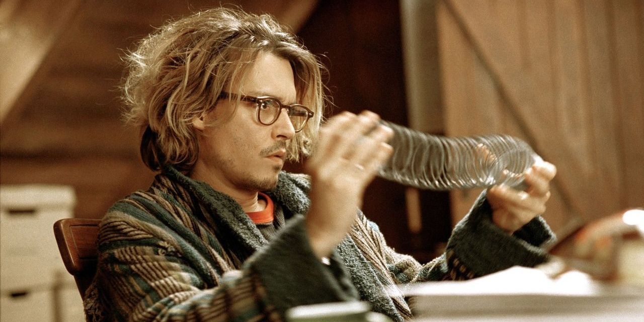 Johnny Depp sits at his desk in Secret Window,