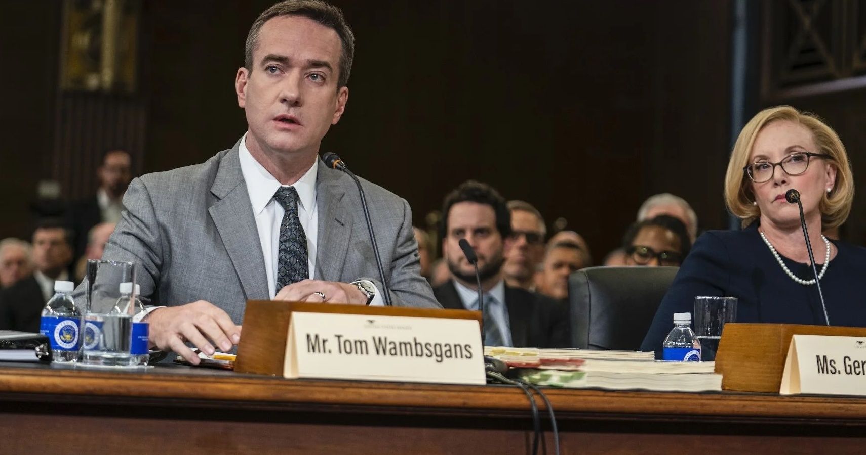 Tom sitting on a table in a Senate hearing