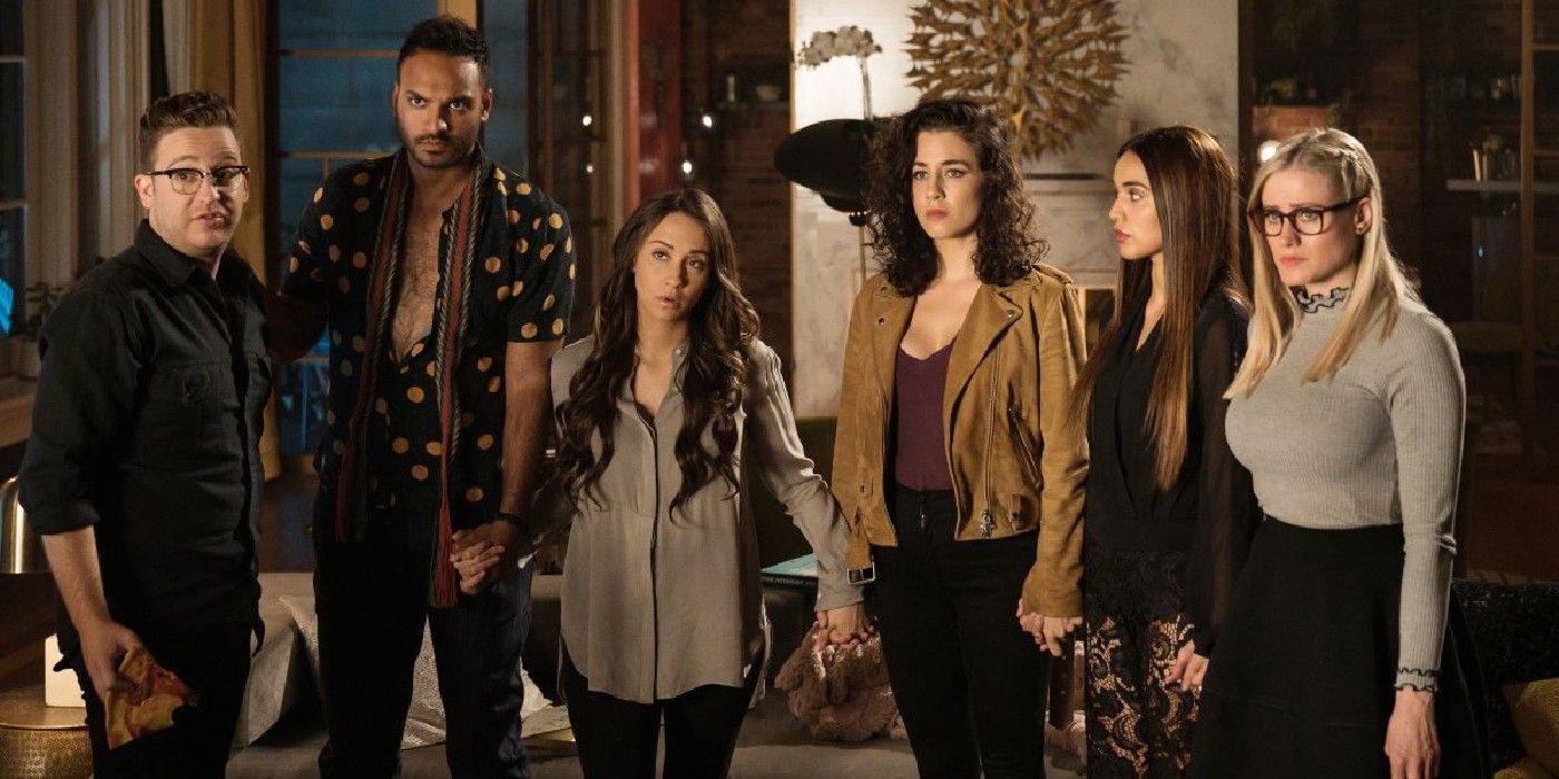 the magicians-group holding hands