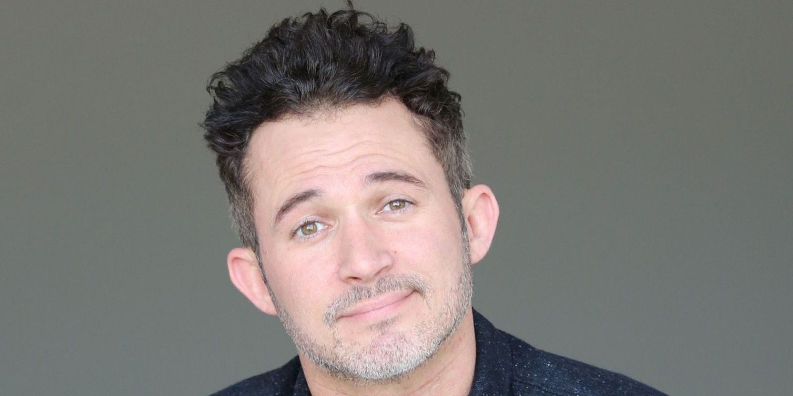 Justin Willman Magic For Humans close up smiling slightly gray background