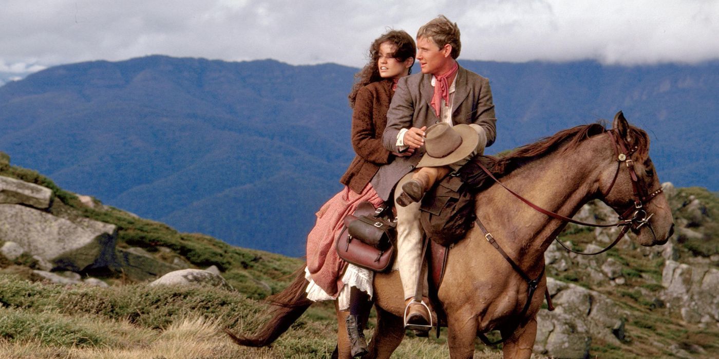 A still of a man and woman embracing on a horse in the movie The Man From Snowy River