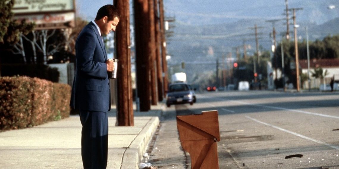 Barry looks at a harmonium on the road in Punch Drunk Love