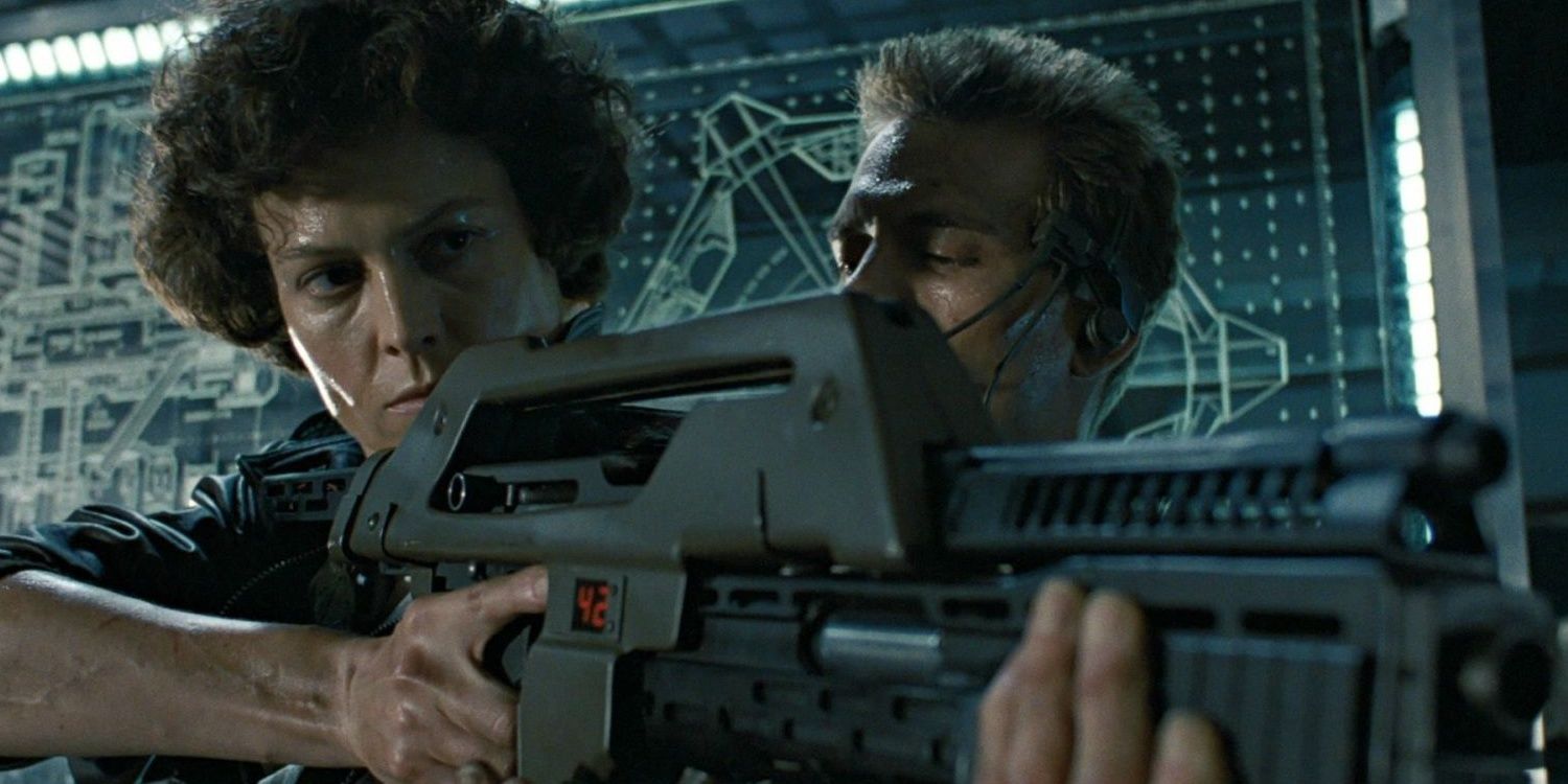 Ripley with a gun being talked to by a soldier in Aliens 1986