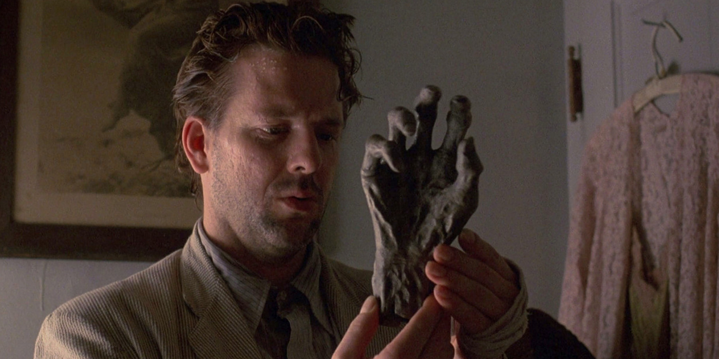 Angel looks at a fake hand from Angel Heart