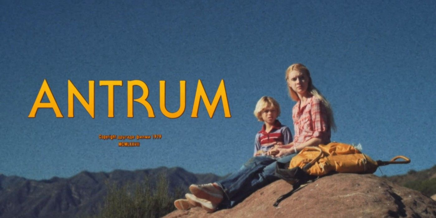 A title card for the movie Antrum, two children sit on a rock