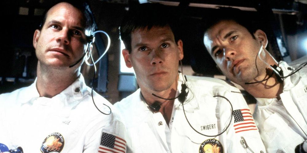 Bill Paxton, Kevin Bacon, and Tom Hanks watch a screen in Apollo 13