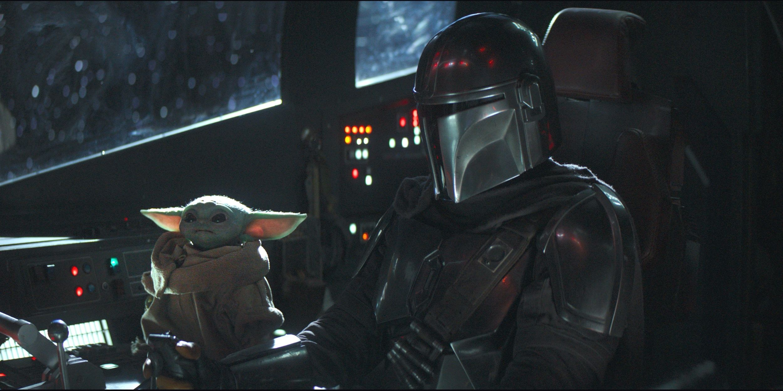 Baby Yoda and Din Djarin in The Mandalorian int he cockpit of the Razor crest