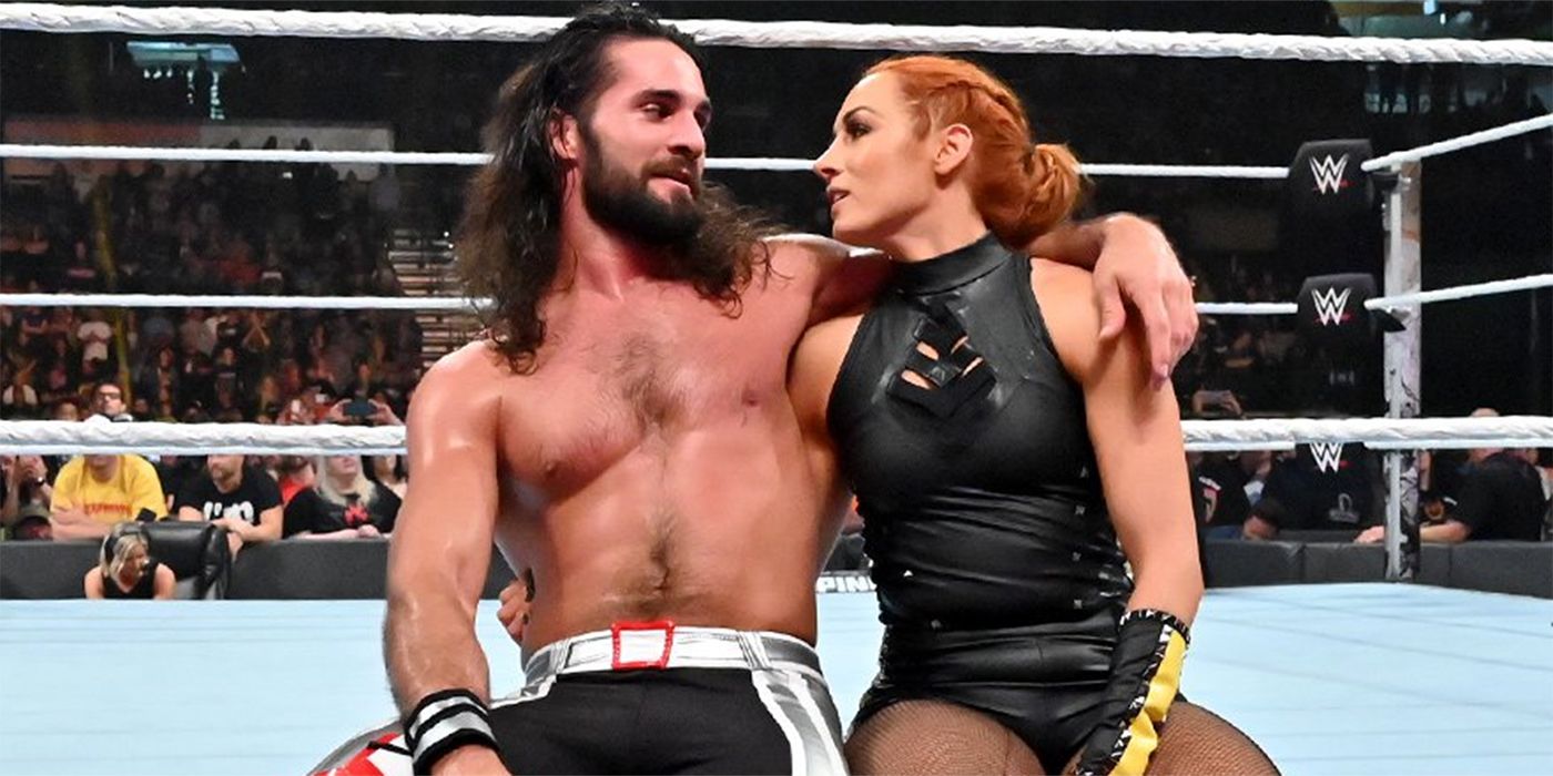 Becky Lynch andSeth Rollins sit on ring aprontogether 