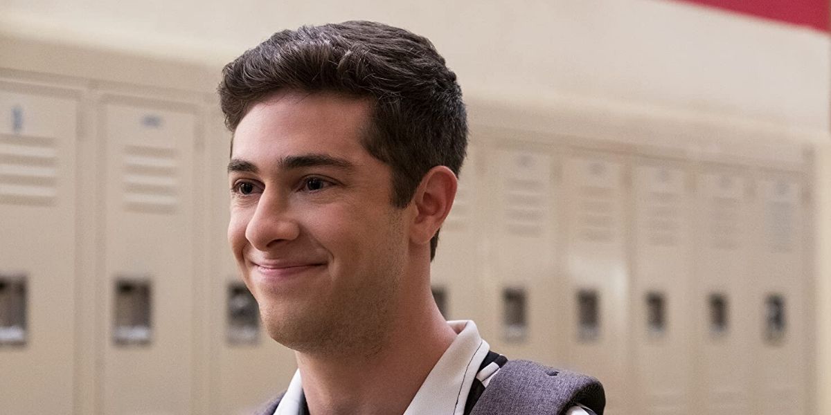 Ben smiling by the lockers in Never Have I Ever