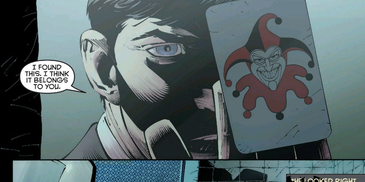 Bruce Wayne holds Joker card in Batman Death of the Family