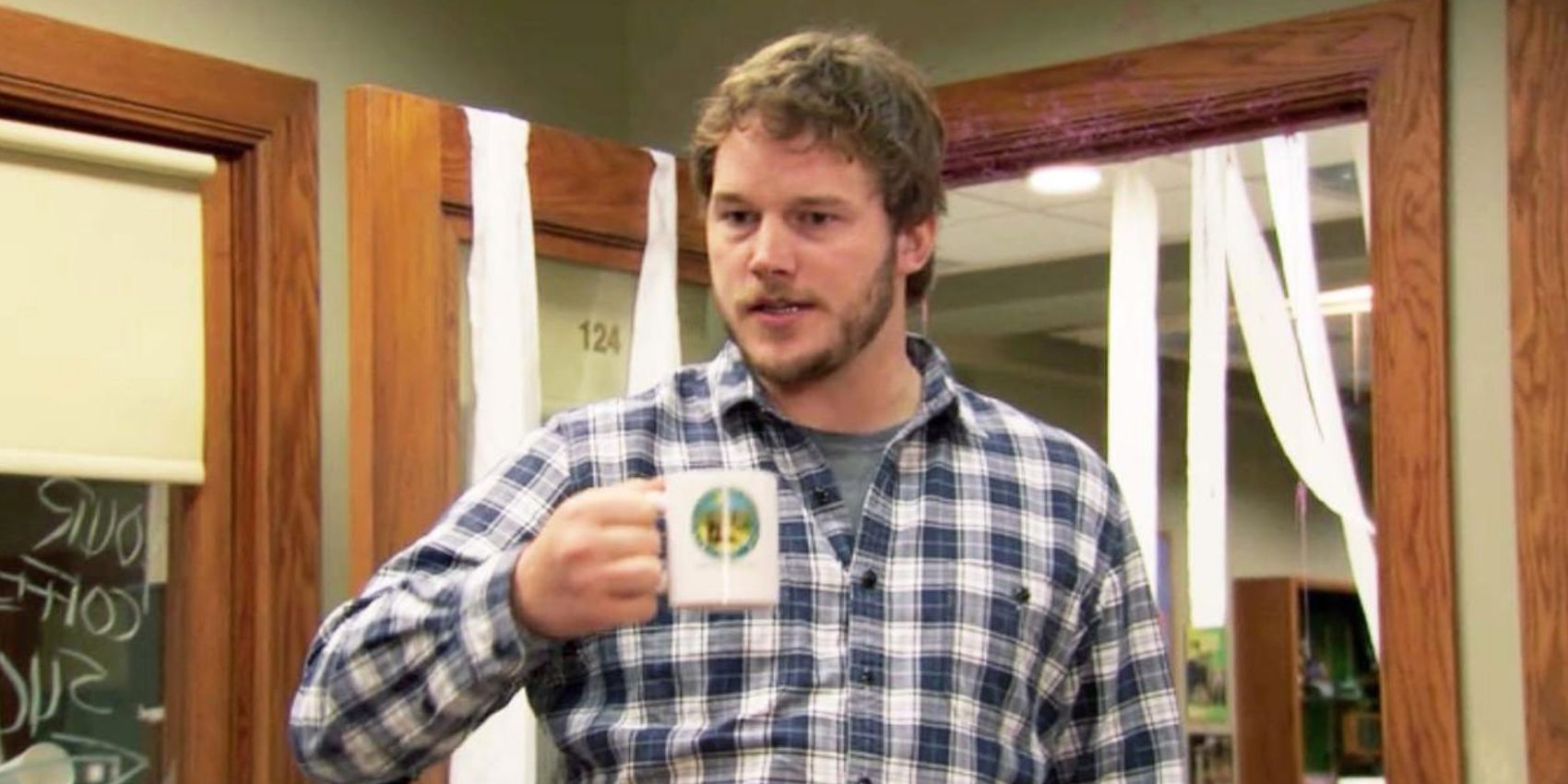 Andy holding a coffee cup In Parks And Recreation