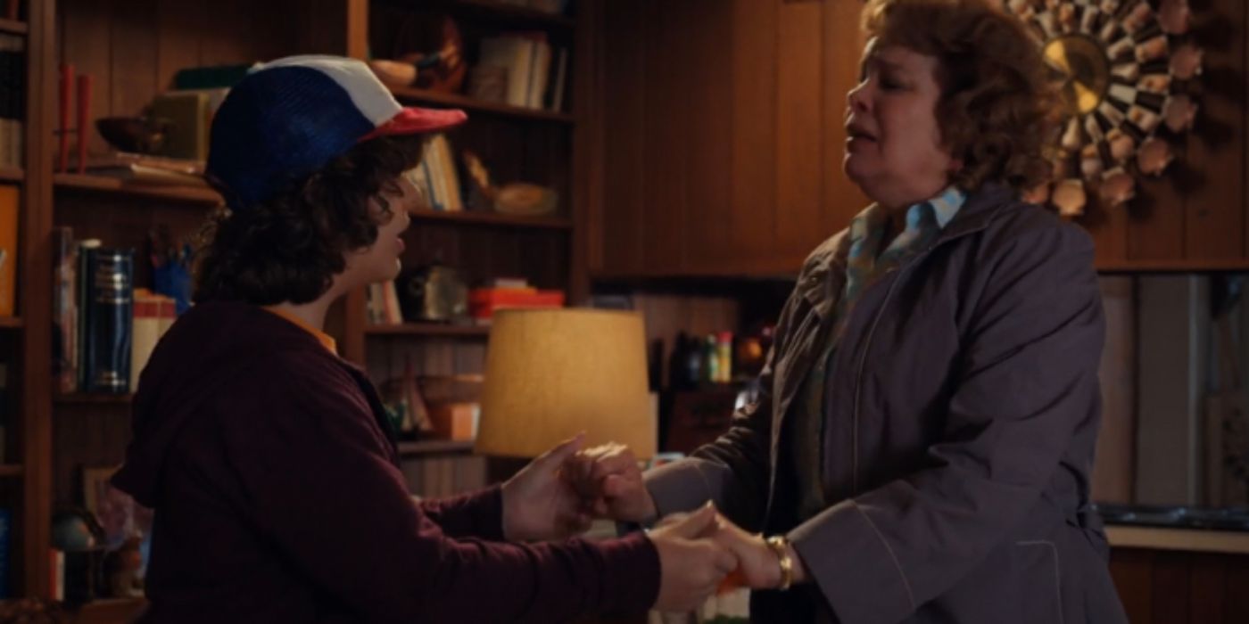 Dustin holds his mothers hands in Stranger Things