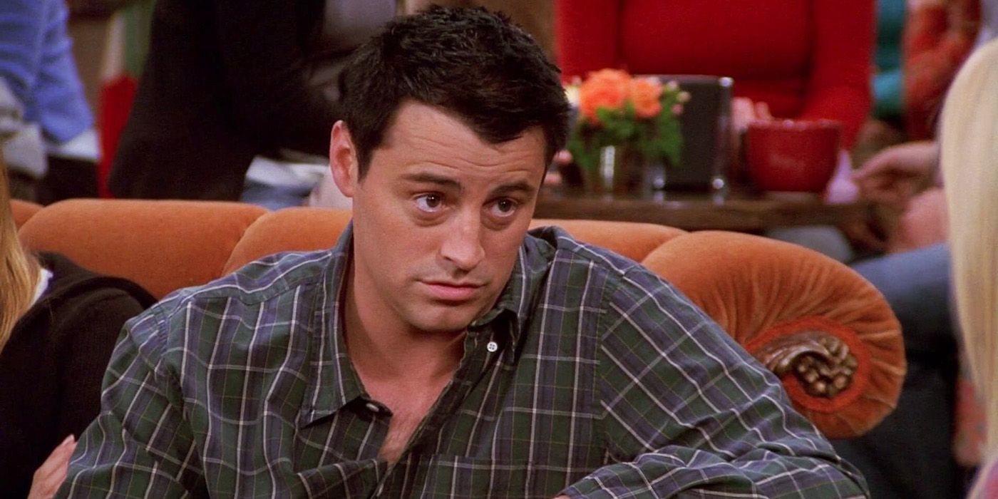 Joey sitting on the couch at Central Perk in Friends.