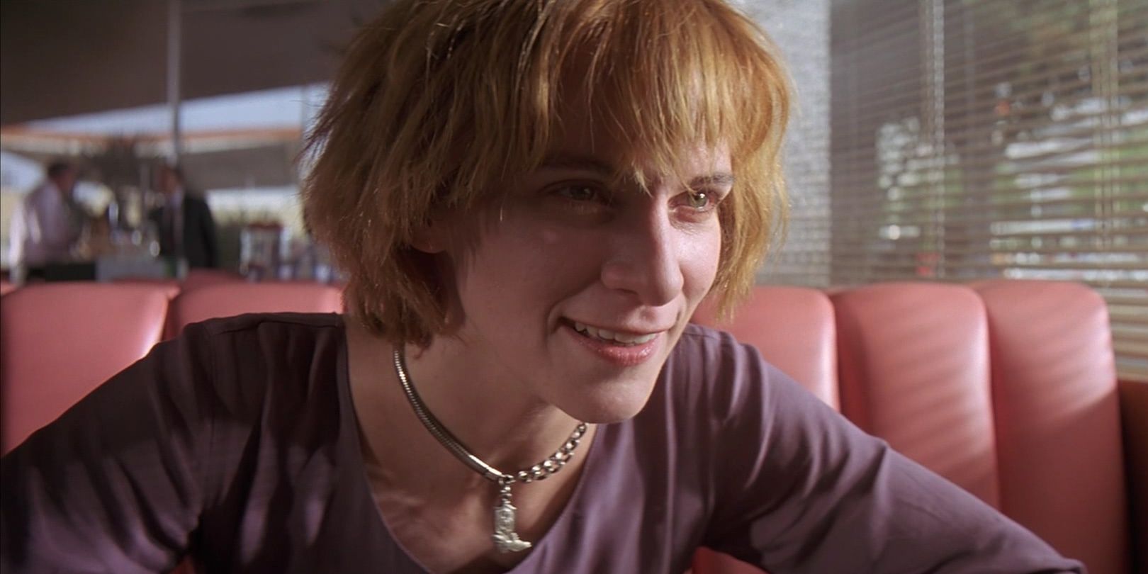 Honey Bunny smiling in a diner booth in Pulp Fiction