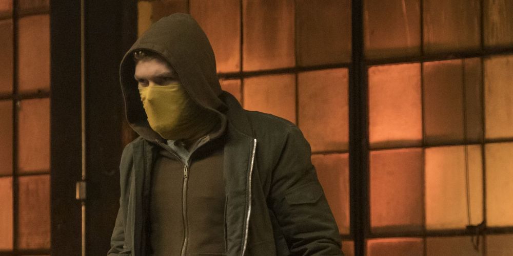 Iron Fist in green hood and yellow mask
