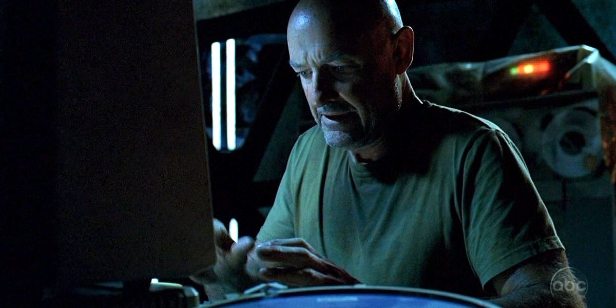 Locke sitting at a computer typing on a keyboard