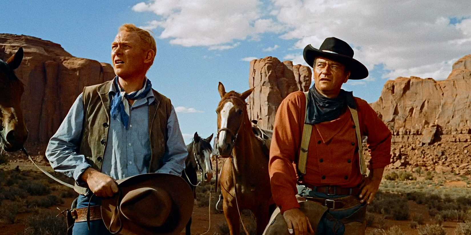 John Wayne as Ethan Edwards by his horse in The Searchers 