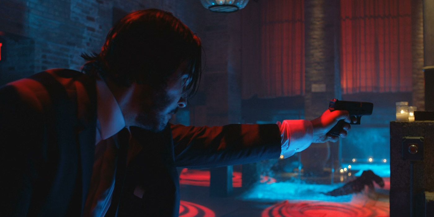 John Wick firing at enemies in a club 