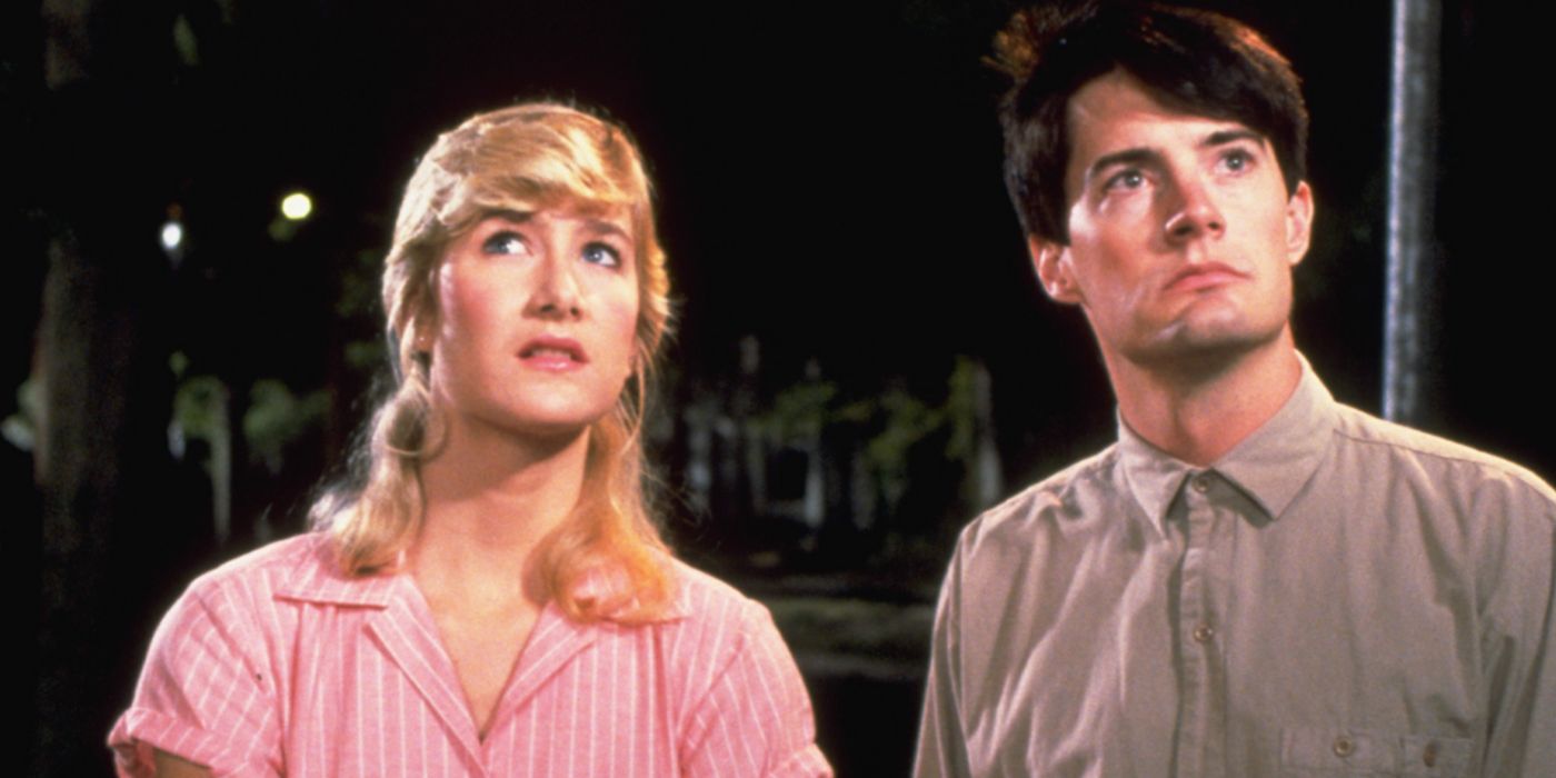 Laura Dern and Kyle MacLachlan standing on the street in Blue Velvet