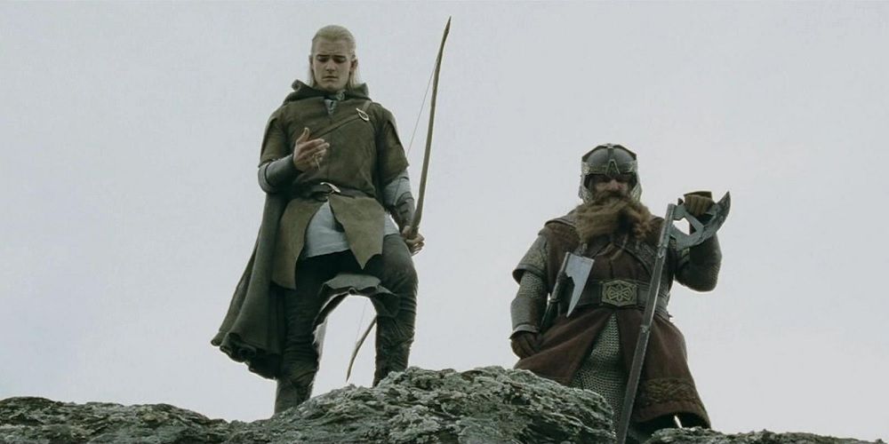 Gimli and Legolas look down on the top of a cliff in Lord of the Rings