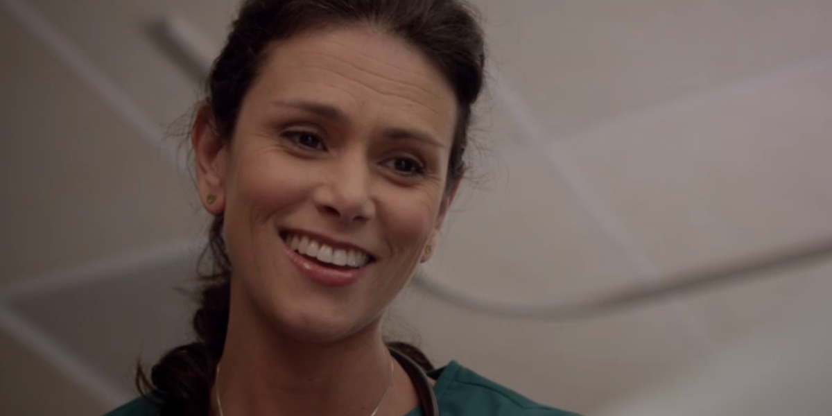 Melissa smiles down at a patient in Teen Wolf
