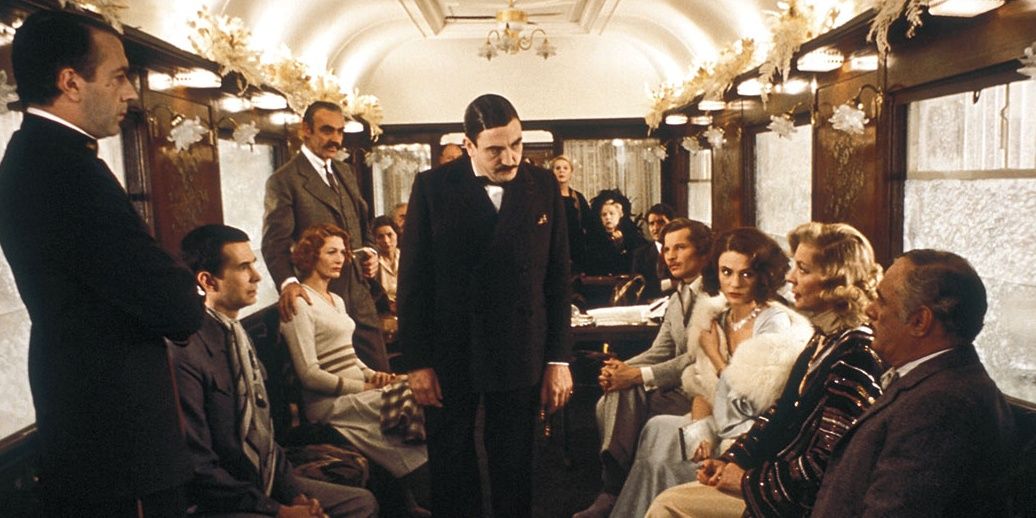 Hercule Poirot stares down suspects in 1974's Murder on the Orient Express