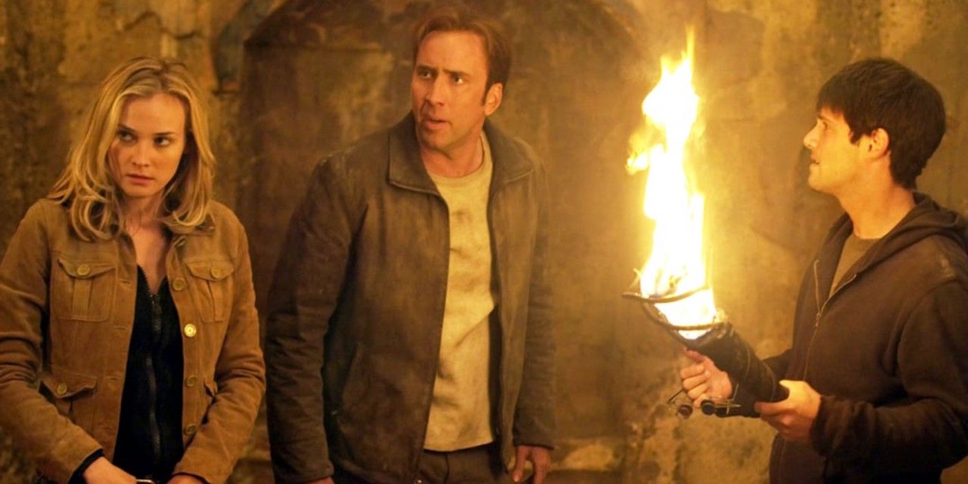 Ben and his two companions with one holding a torch in National Treasure