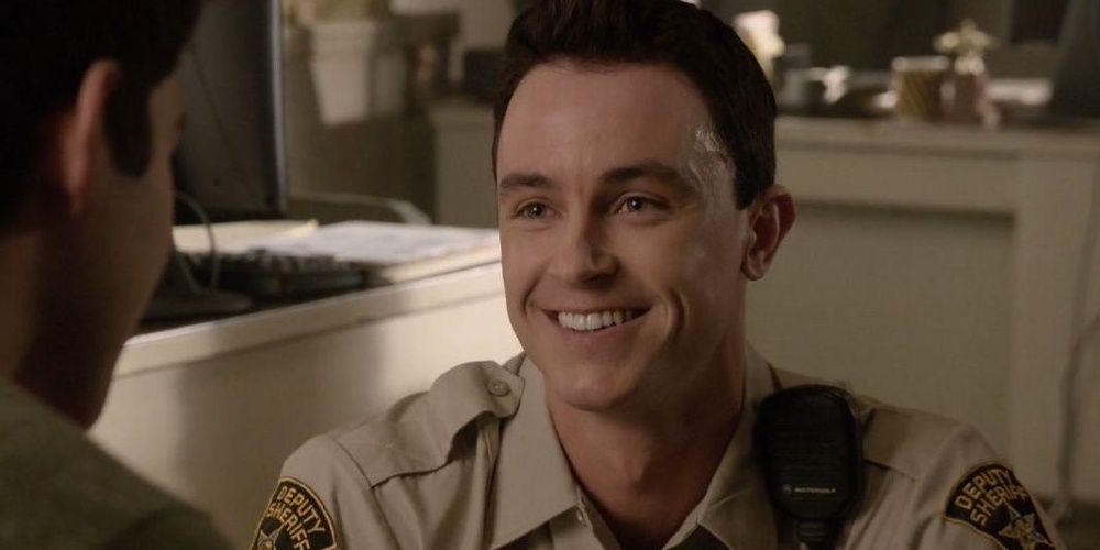 Parrish smiles while talking with Scott in Teen Wolf