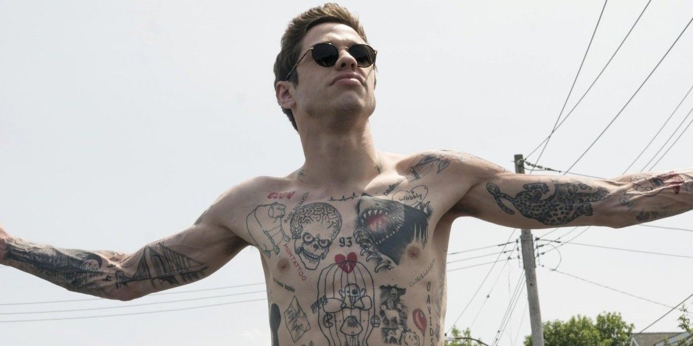 Pete Davidson shirtless with his arms open in The King of Staten Island.