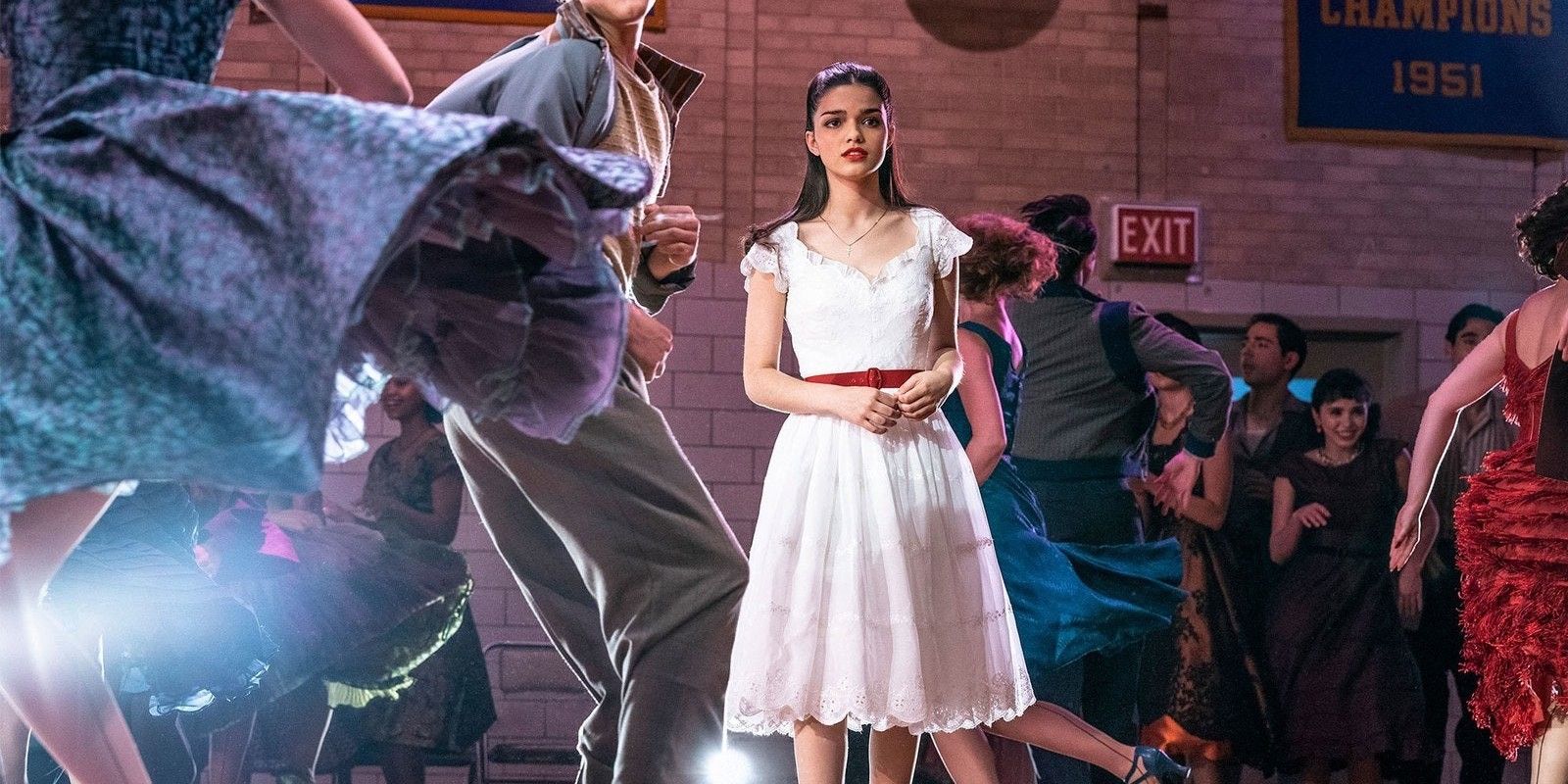 Maria standing in the middle of a school dance in West Side Story