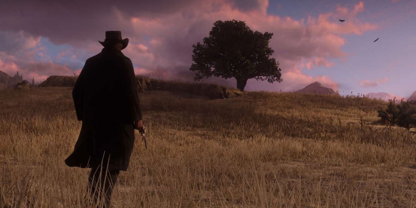 Arthur Morgan standing in a grassy field with a purple sky overhead in RDR2