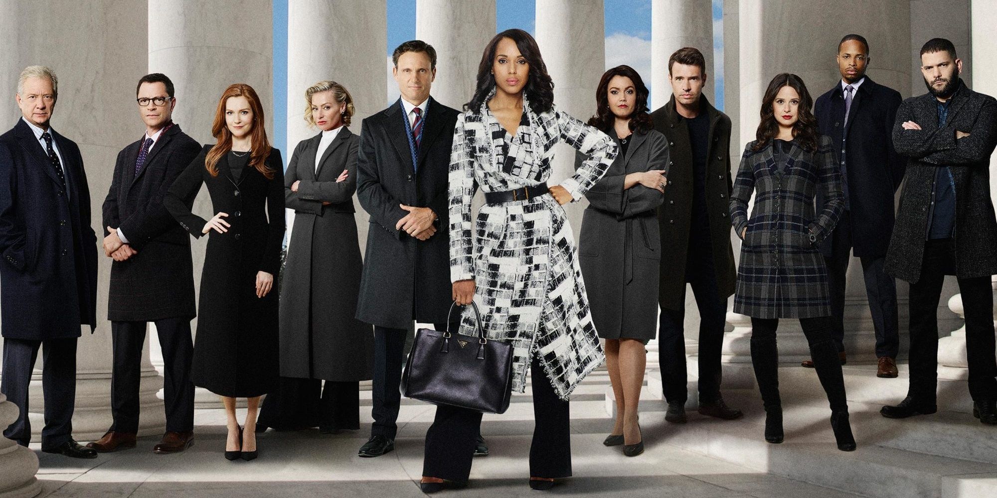 The cast of Scandal wearing black and white suits and jackets in front of the Capitol columns