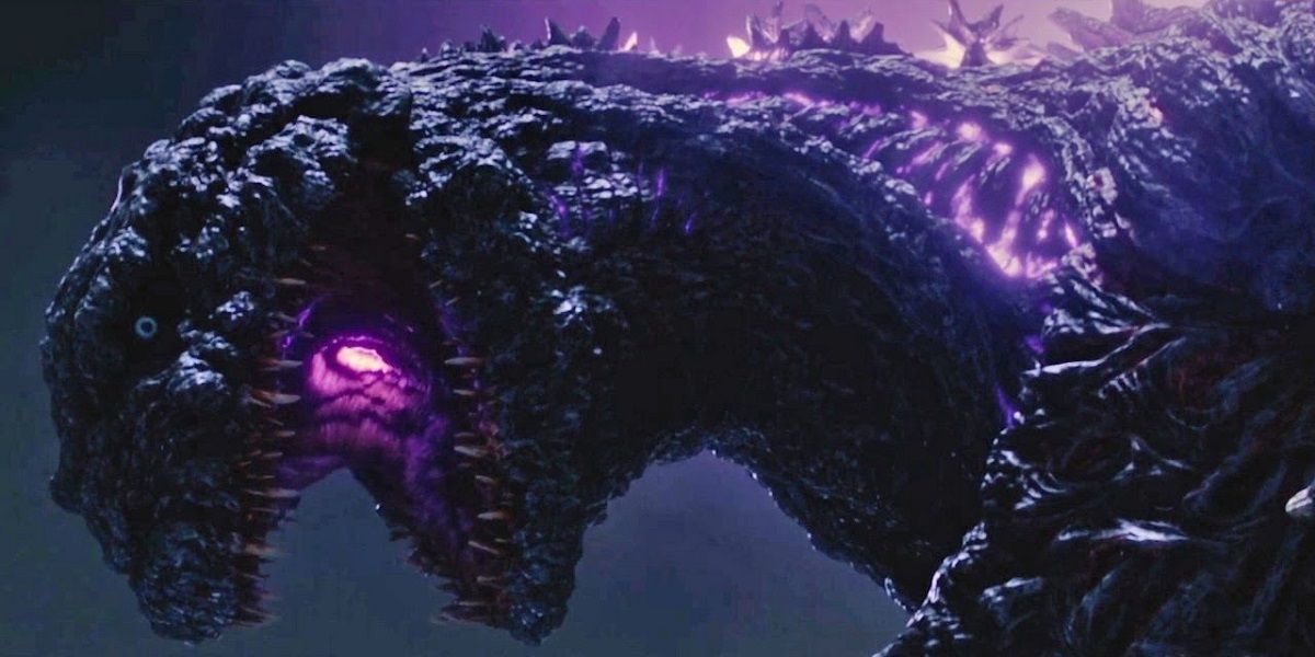 Godzilla in Shin Godzilla with purple light and mouth open.