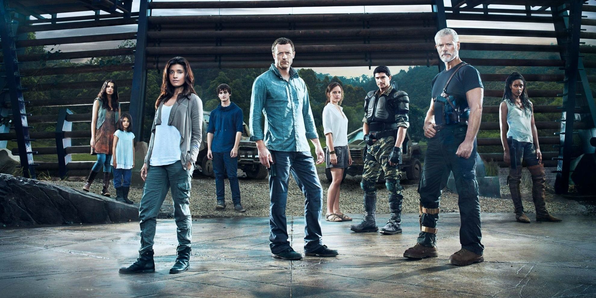 The cast of Terra Nova pose in front of gates