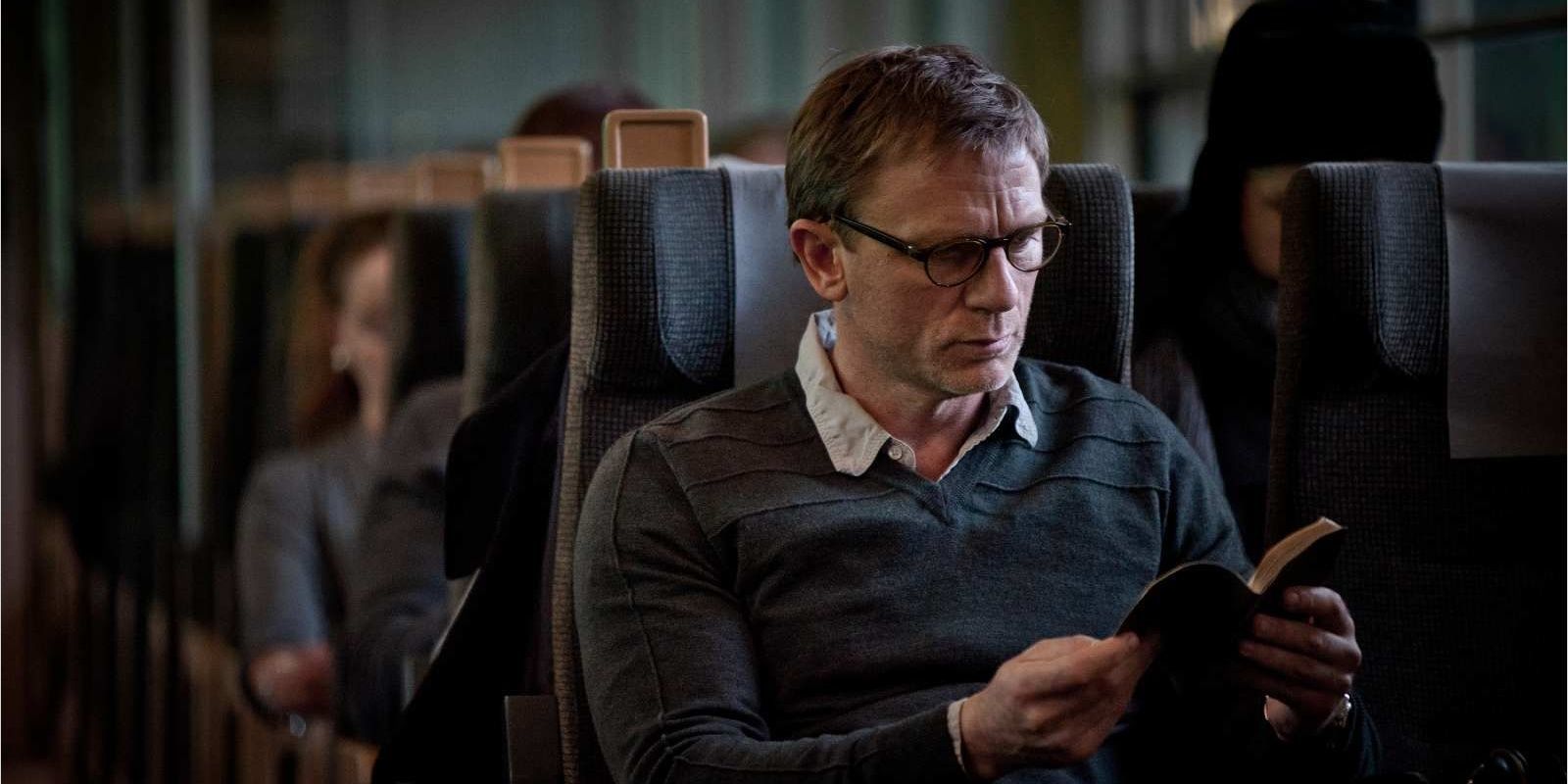 Mikael reads a book in The Girl with the Dragon Tattoo