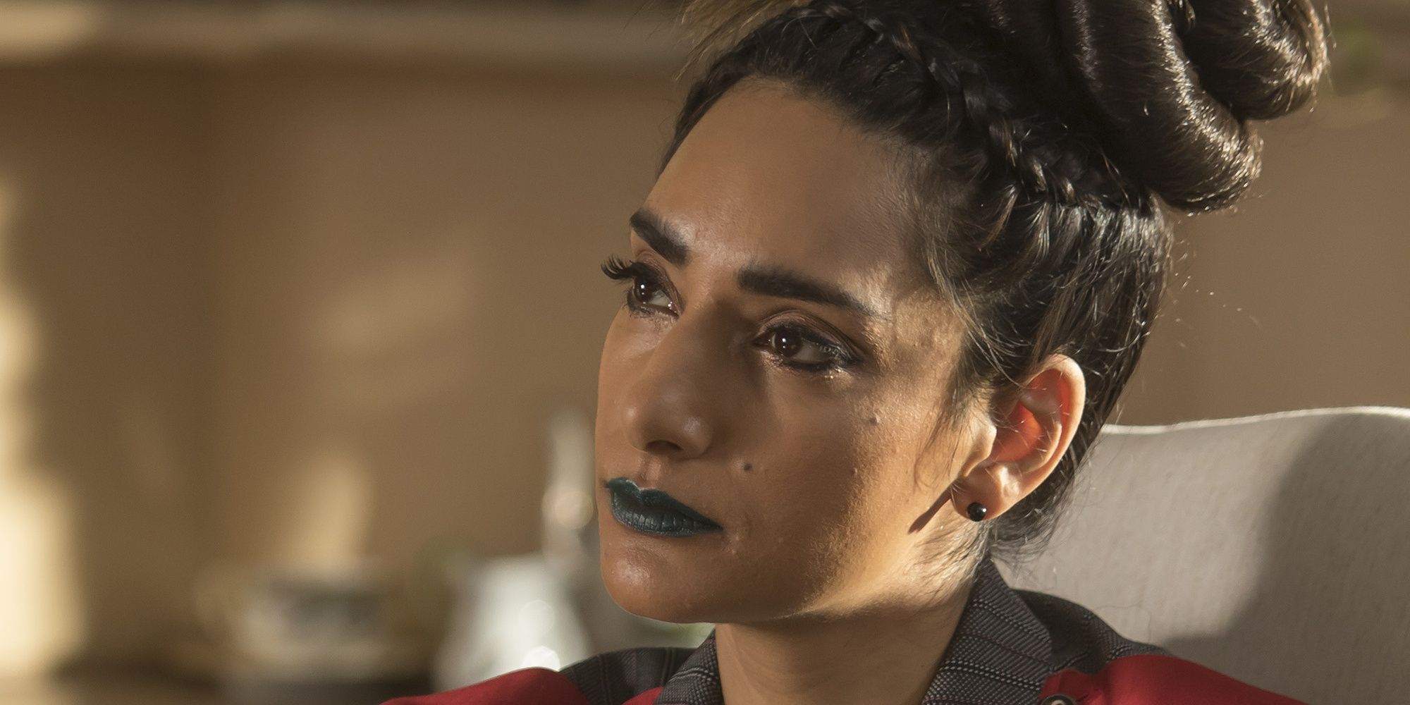 A close-up of Kamilah looking serious in The Good Place