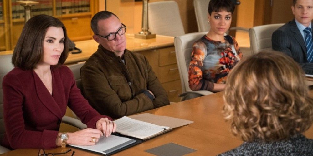 Finn and Alicia sit at a large desk in a meeting in The Good Wife
