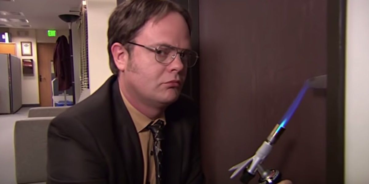 An image of Dwight heating up a door handle in The Office