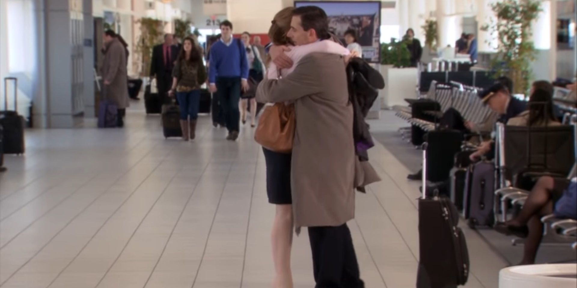 Pam and Michael hug before he leaves on his flight in The Office