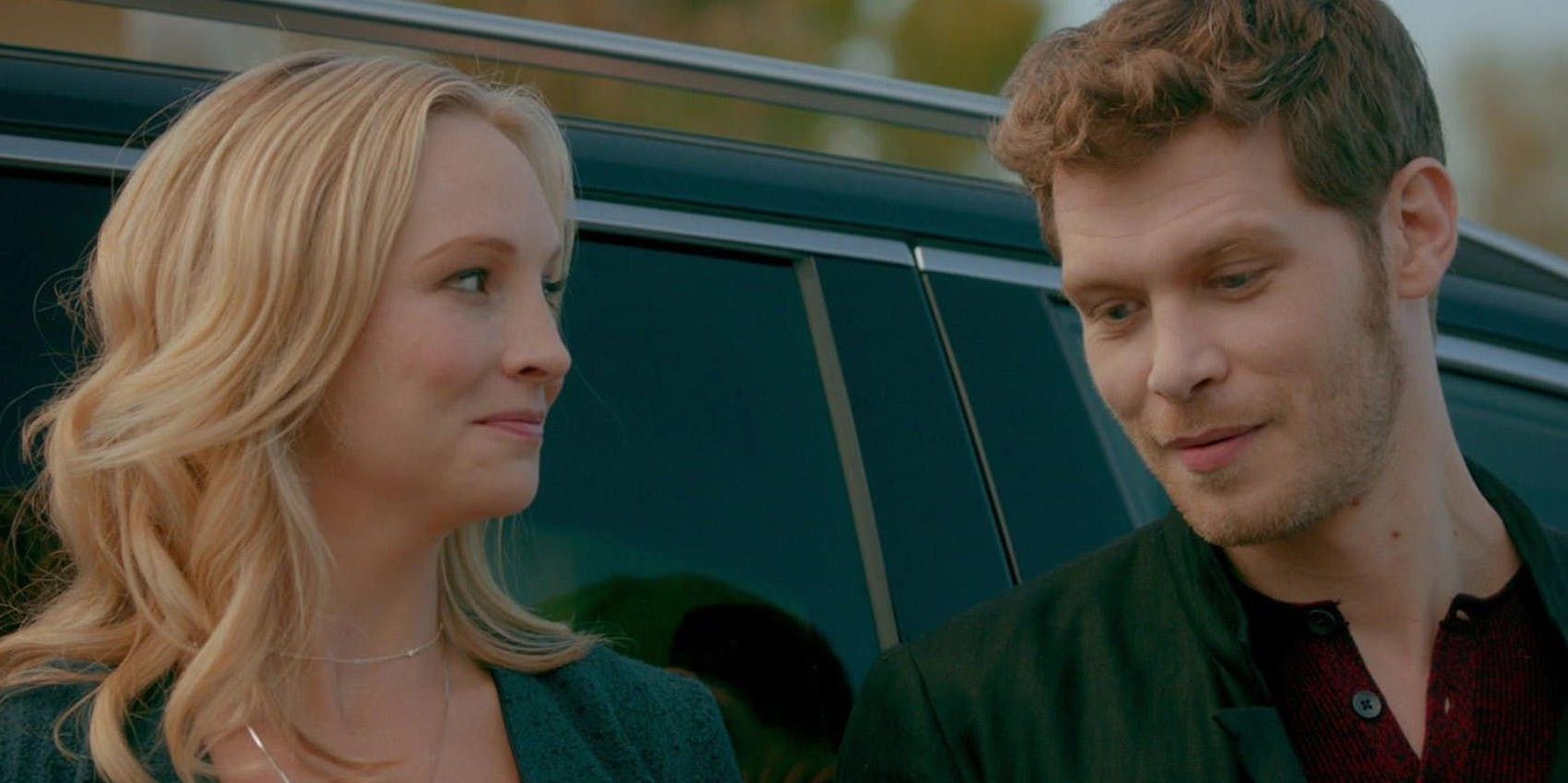 Klaus and Caroline in The Vampire Diaries leaning up against a car.