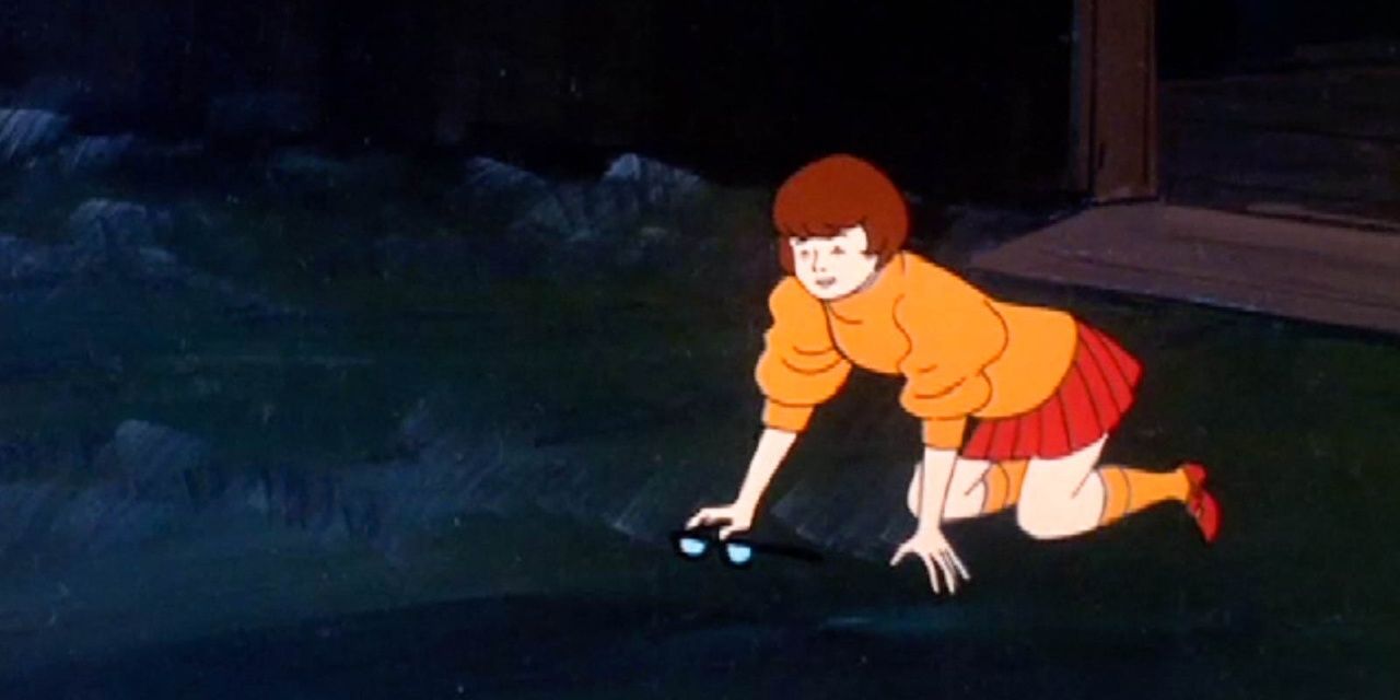 Velma searches for her glasses on the ground in Scooby-Doo