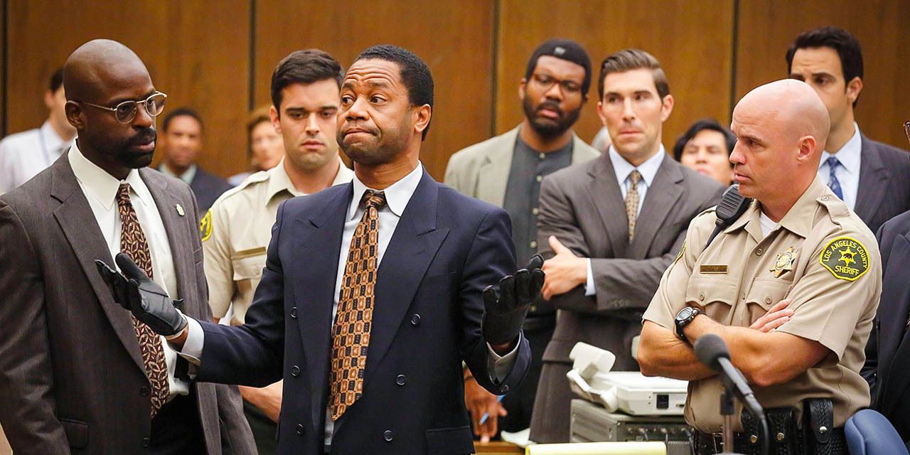 OJ Simpson standing with his arms open in the court in American Crime Story