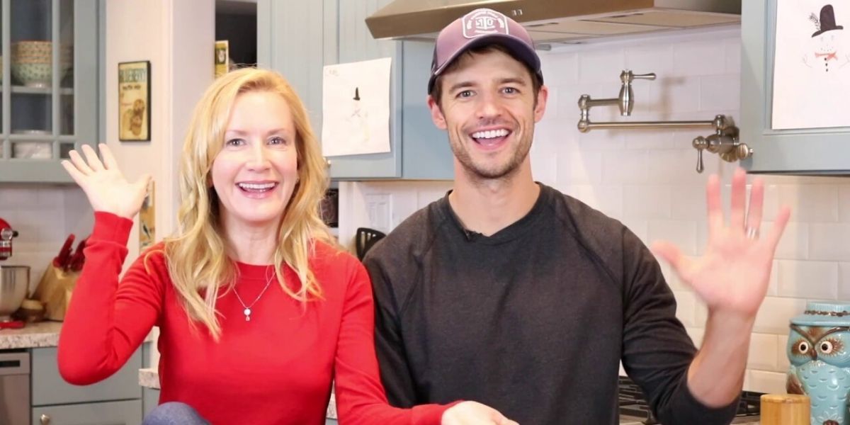 Angela Kinsey And Joshua Snyder waving from their kitchen