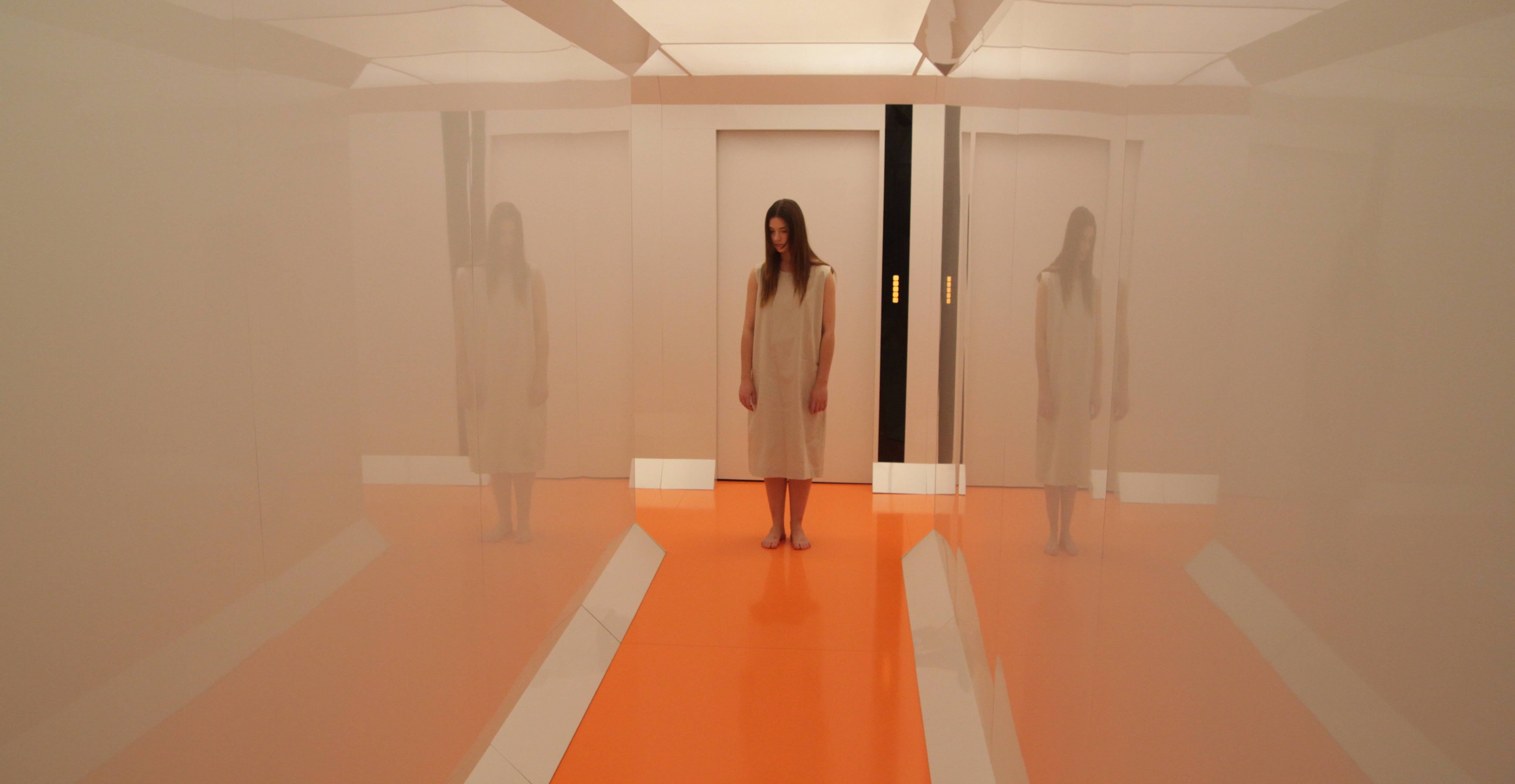 A woman in the hallway in Beyond the Black Rainbow