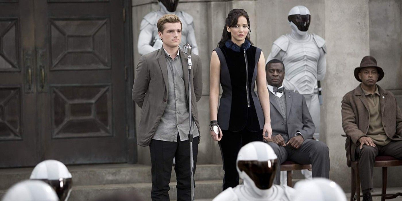 Peeta and Katniss standing in District 11 in The Hunger Games
