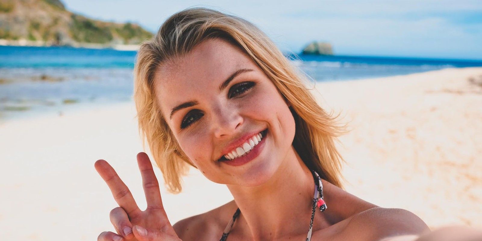 Andrea Boehlke giving the peace sign on Survivor
