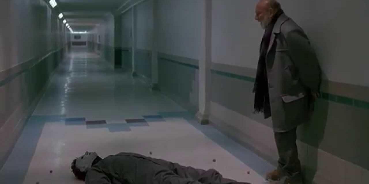 Loomis looks down at the prone corpse of Michael Myers from Halloween 6