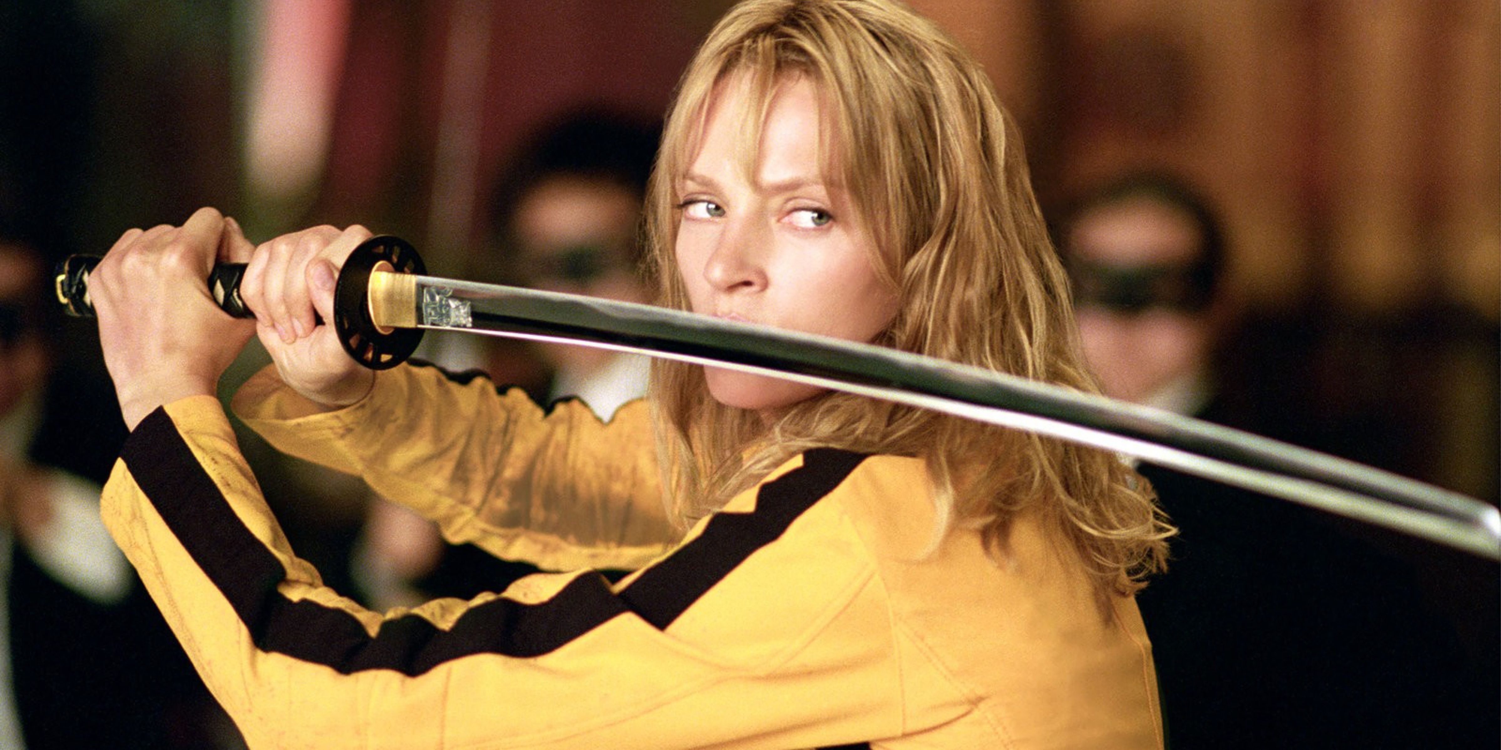 The Bride fights with her machete in her iconic yellow motorbike suit in Kill Bill