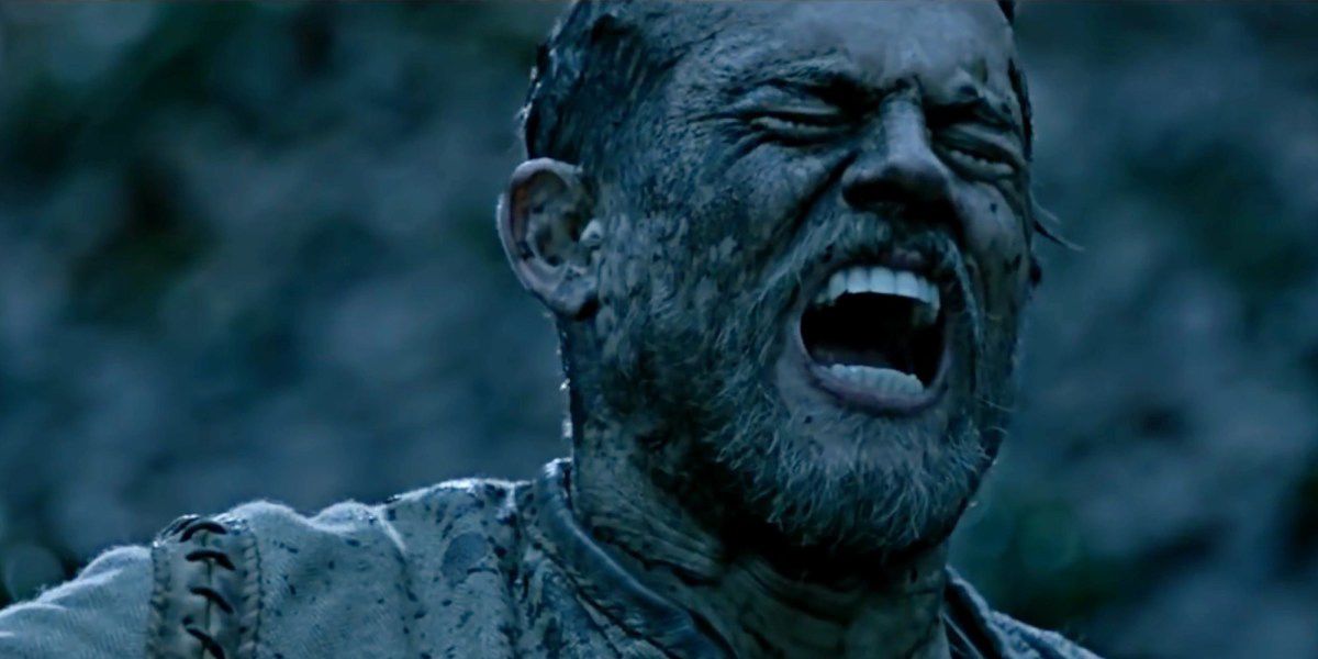 Charlie Hunnam as Arthur screaming and muddy in King Arthur: Legend of the Sword